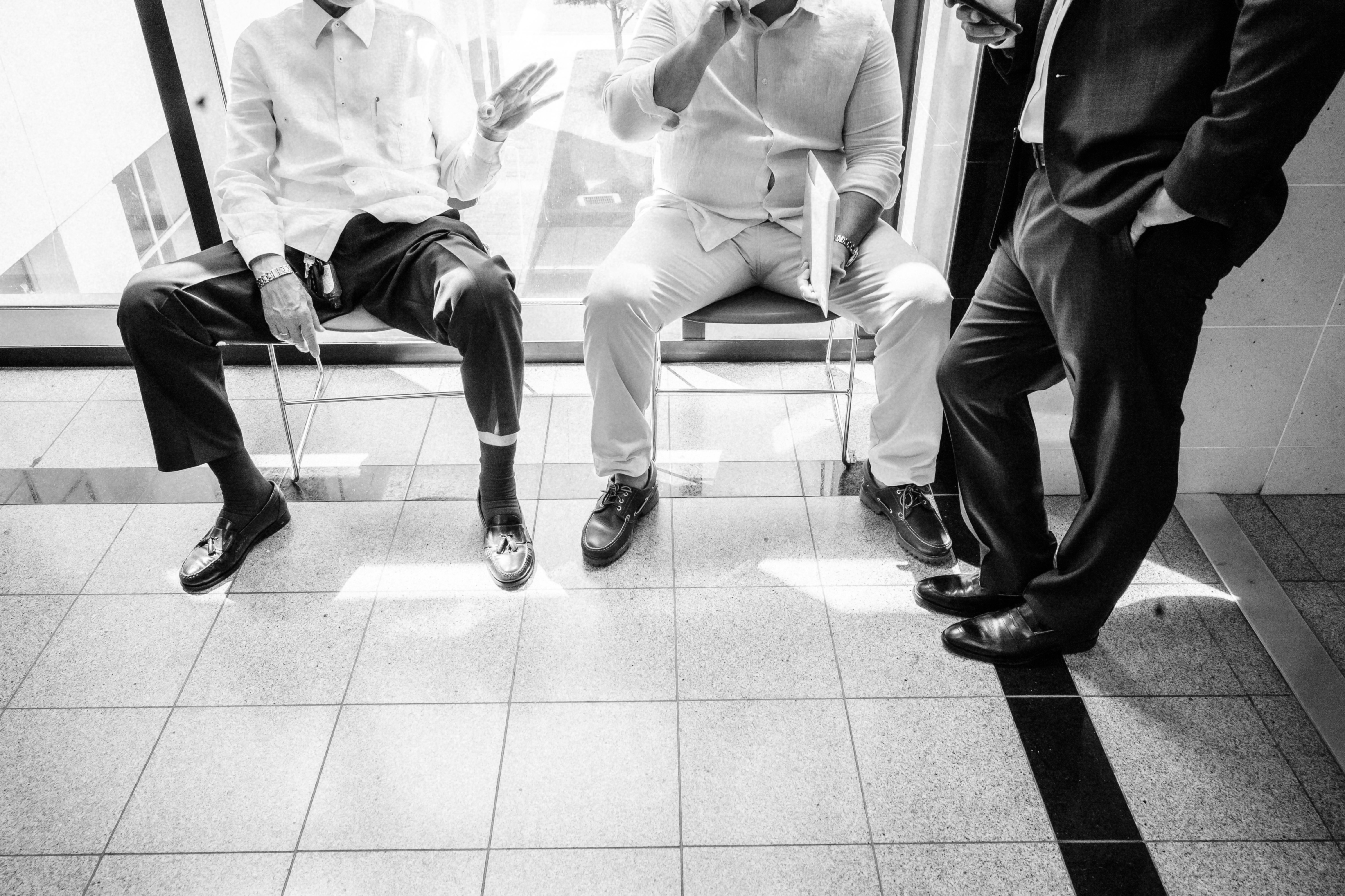 man in white dress shirt sitting on chair